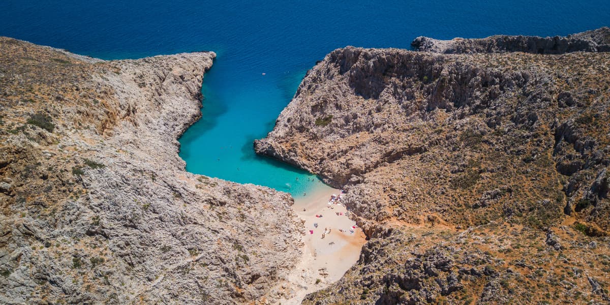 Aerial view of a private speedboat in the turquoise coves of Souda Bay, Crete